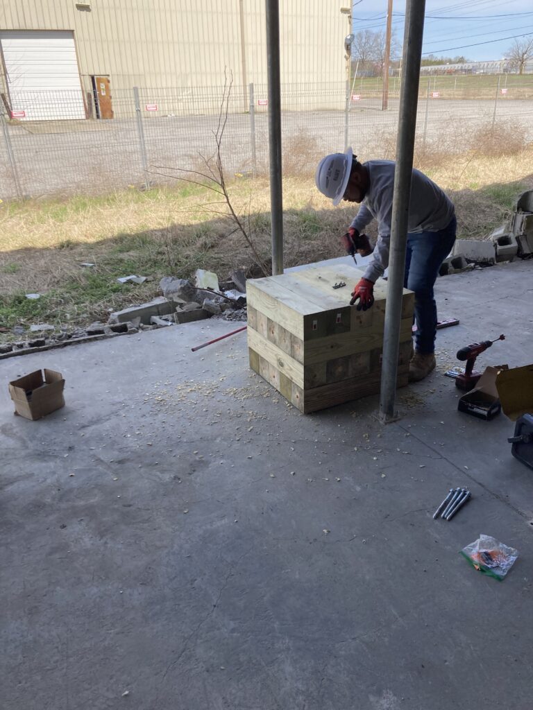 Construction worker prepping for temporary structural support
